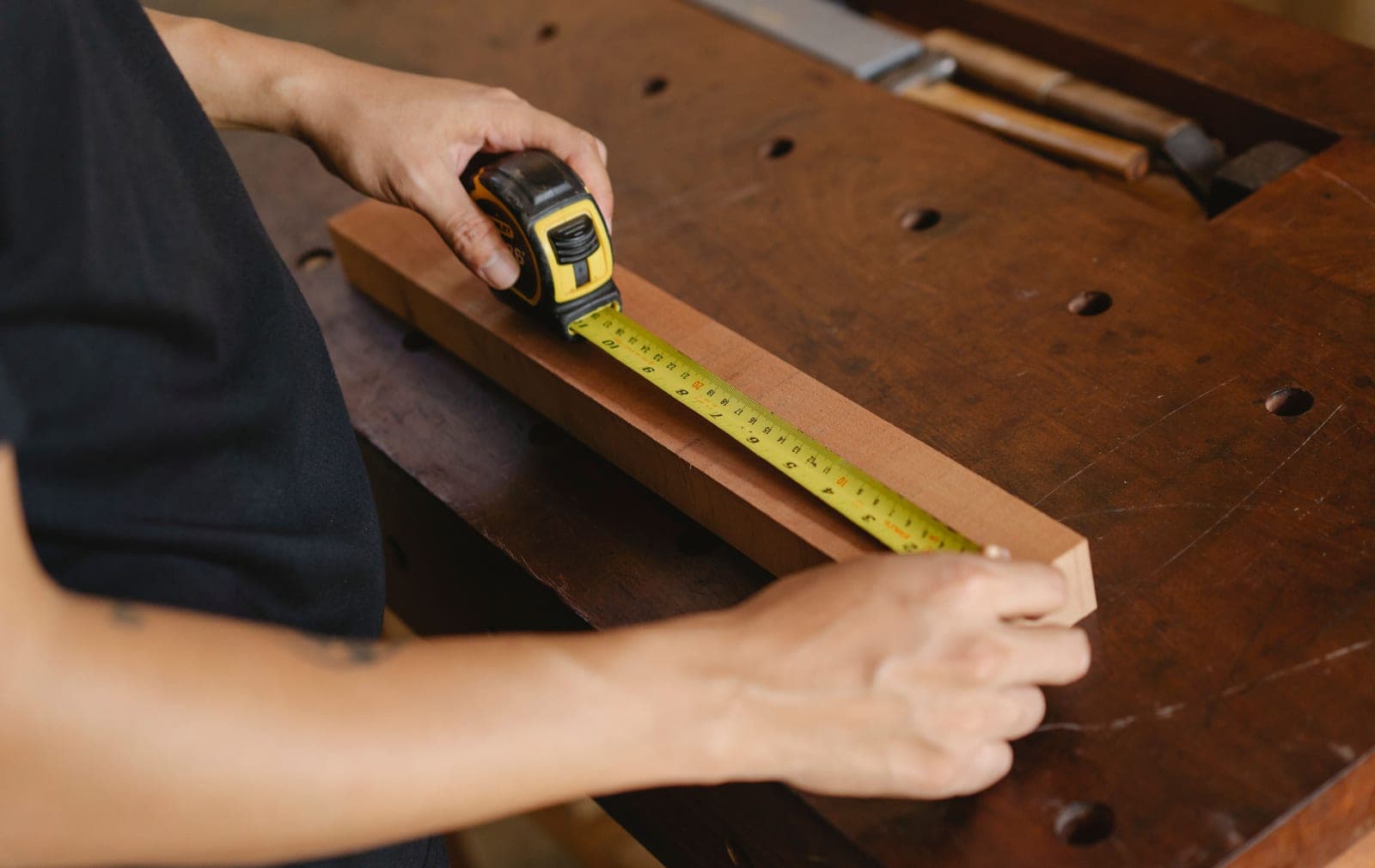 Measuring a wooden panel with a rule