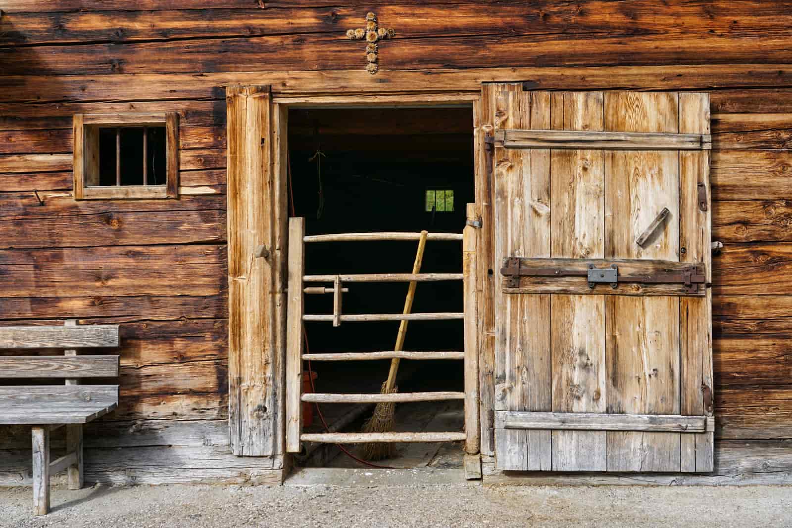 An open barn door with air moving into a stable
